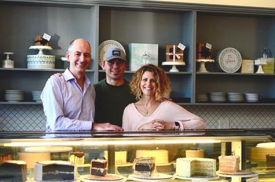Owners Nick and Andi with their CBA Eric by the cake display